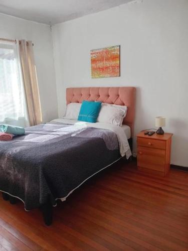 a bedroom with a large bed and a wooden floor at Hostal Gloria Viña 2 poniente 333 in Viña del Mar