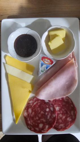 a plate of food with cheese and other foods on it at Sweet Dreams in San Carlos