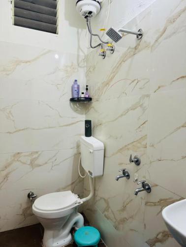 a bathroom with a toilet and a sink at Your Home in Indore