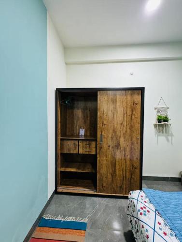 a room with a large wooden door and a bed at Your Home in Indore