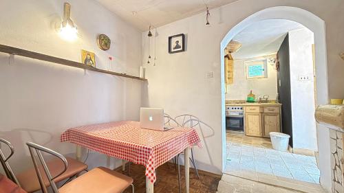 a kitchen with a table with a laptop on it at Blueberry Mountain House in Žabljak