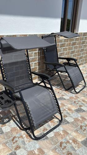 two chairs and a table on a patio at Appartement au cœur de la nature route Saïdia in Berkawe