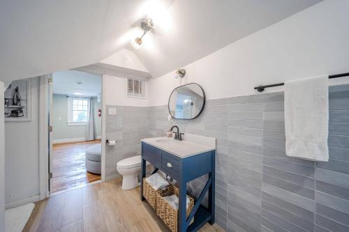 a bathroom with a blue sink and a toilet at Cozy Cottage House - Pool & Hot Tub in Ferndale