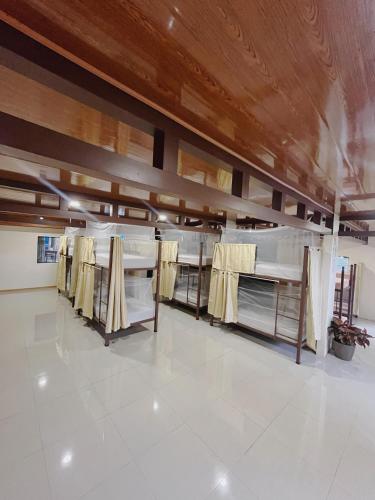 a room with a row of beds on display at hostel Mar y Bosque in Drake