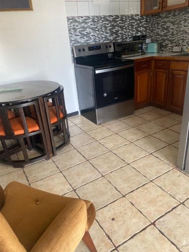a kitchen with a table and a stove top oven at Hotel Manuel Antonio Inn in Quepos
