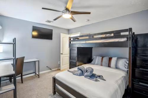 a bedroom with a bed and a ceiling fan at Tropical Escape Pool Jacuzzi Bar in Alvin TX in Alvin