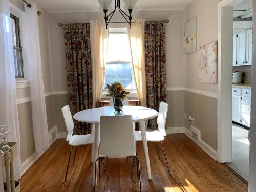 a dining room with a white table and chairs at Home Away from Home Stay - 2 Bedroom,1 Bathroom - Near Capitol Hill in Washington, D.C.