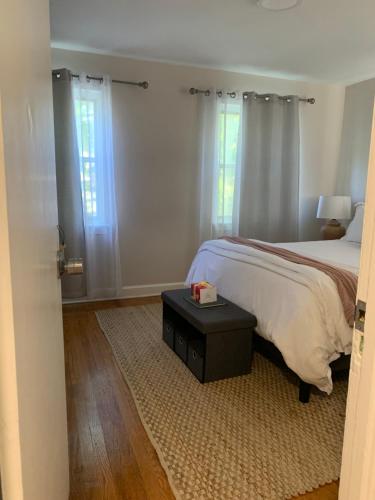 a bedroom with a bed and a table and windows at Home Away from Home Stay - 2 Bedroom,1 Bathroom - Near Capitol Hill in Washington, D.C.