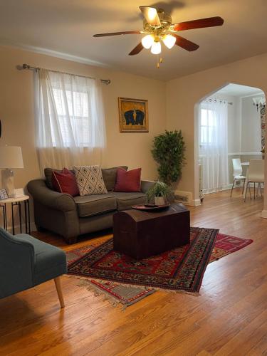 a living room with a couch and a ceiling fan at Home Away from Home Stay - 2 Bedroom,1 Bathroom - Near Capitol Hill in Washington, D.C.