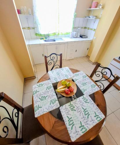 a dining room table with a bowl of fruit on it at Sol de Paracas Apart Hotel Pisco in Pisco