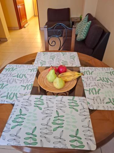 two tables with a bowl of fruit and vegetables on them at Sol de Paracas Apart Hotel Pisco in Pisco