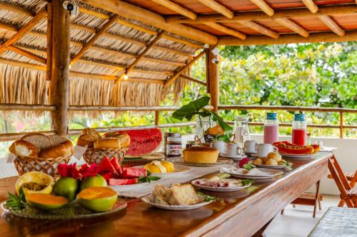 a table with a bunch of food on it at Pousada Maria do Lampião Jericoacoara- Antigo Jeri Vila Mini in Jericoacoara