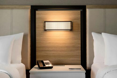 a phone on a table between two beds at SpringHill Suites by Marriott Roanoke in Roanoke