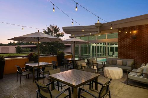 a patio with tables and chairs and a couch at SpringHill Suites by Marriott Roanoke in Roanoke