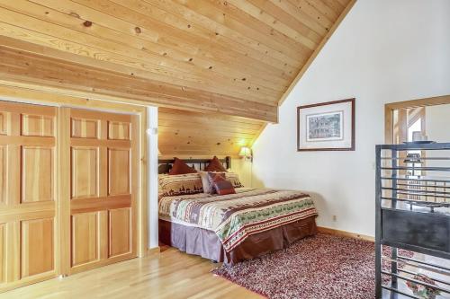 a bedroom with a bed and a wooden ceiling at Beautiful Peak 7 Private Home in Breckenridge