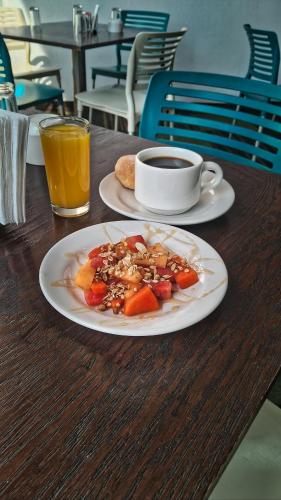 a table with a plate of food and a cup of coffee at Hotel Del Angel Reforma in Mexico City