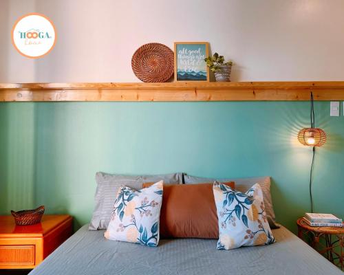 a bedroom with a bed with a wooden headboard at Hooga Home in Cebu City