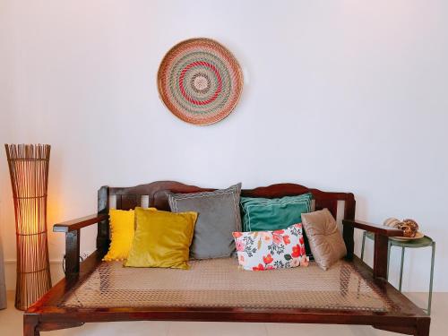 a couch with colorful pillows on it in a room at Hooga Home in Cebu City