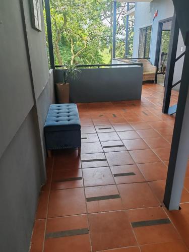 a hallway with a bench sitting on a tiled floor at Hotel Manuel Antonio Inn in Quepos