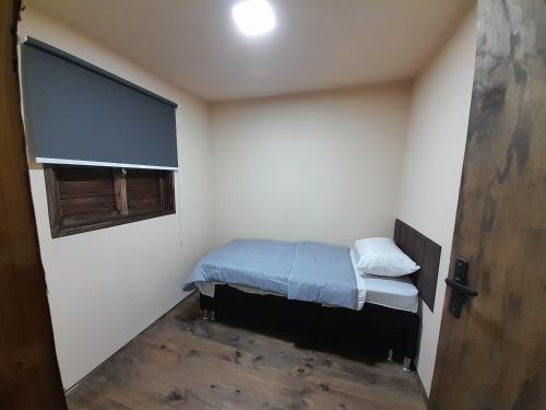 a small room with a bed and a window at Cabañas CARPE DIEM Con o sin jacuzzi in Barra del Chuy