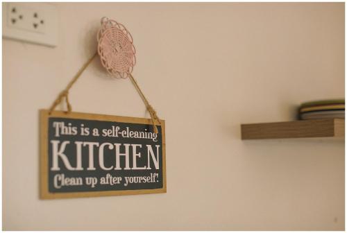 a sign that reads this is a self awakening kitchen clean up after yourself at Hooga Home in Cebu City
