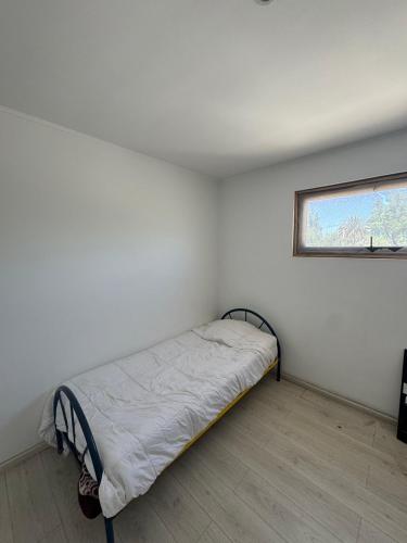a small bedroom with a bed in a room with a window at casa mediterranea in Calera de Tango