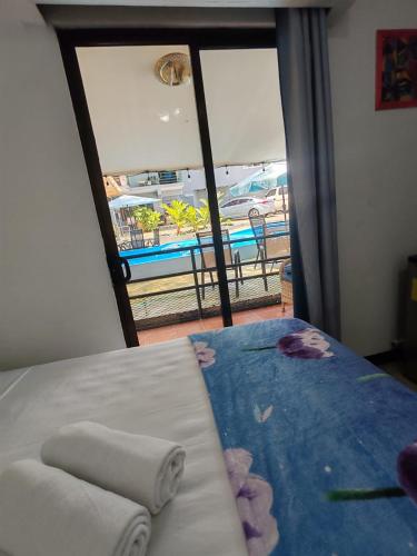 a bedroom with a bed with a view of a beach at Hotel Manuel Antonio Inn in Quepos
