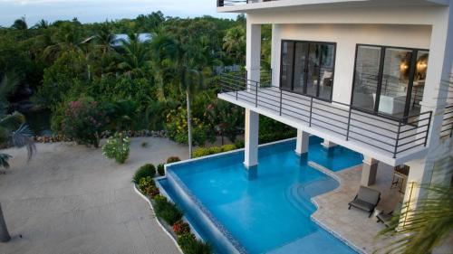 an aerial view of a house with a swimming pool at NEW 3 Story Waterfront 4Bedroom Villa with Amazing Sunset Mountain Views in Maya Beach