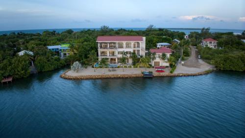 an aerial view of a house on a island in the water at NEW 3 Story Waterfront 4Bedroom Villa with Amazing Sunset Mountain Views in Maya Beach