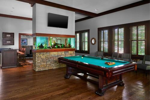 a pool table in a room with a fish tank at Montgomery Marriott Prattville Hotel & Conf Ctr at Capitol Hill in Prattville