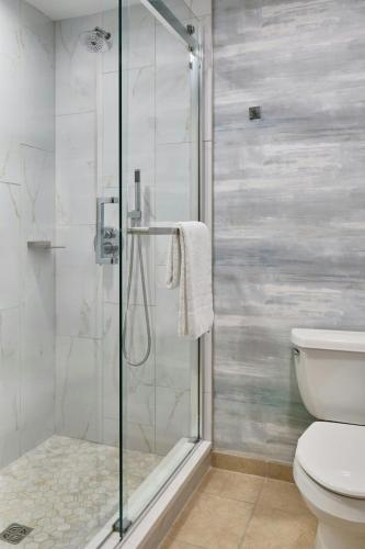 a bathroom with a shower and a toilet at Montgomery Marriott Prattville Hotel & Conf Ctr at Capitol Hill in Prattville