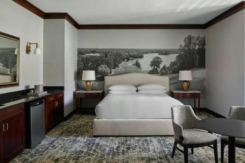 a bedroom with a bed and a table and chairs at Montgomery Marriott Prattville Hotel & Conf Ctr at Capitol Hill in Prattville