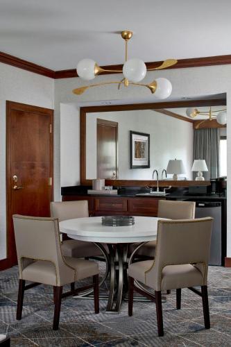 a dining room with a table and chairs and a kitchen at Montgomery Marriott Prattville Hotel & Conf Ctr at Capitol Hill in Prattville