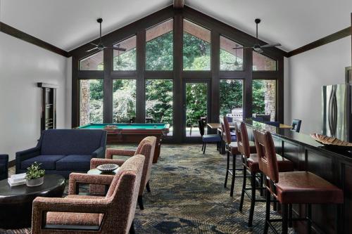 a living room with couches and a pool table at Montgomery Marriott Prattville Hotel & Conf Ctr at Capitol Hill in Prattville