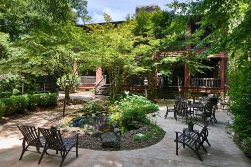 a patio with chairs and a pond and trees at Montgomery Marriott Prattville Hotel & Conf Ctr at Capitol Hill in Prattville
