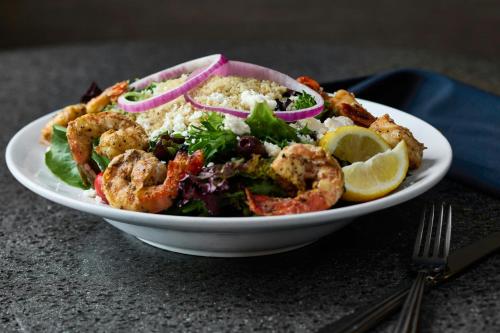 a plate of shrimp salad with lettuce and onions at Montgomery Marriott Prattville Hotel & Conf Ctr at Capitol Hill in Prattville