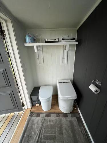a small bathroom with a toilet and a window at Cabin in Silisjávri in Skillemo