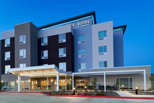 a rendering of the suites building at the campus at TownePlace Suites by Marriott Houston Tomball in Tomball