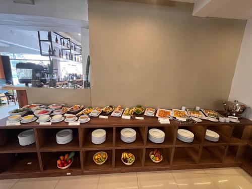 a buffet line with plates of food on display at Velvet Sunrise Hotel in Machu Picchu