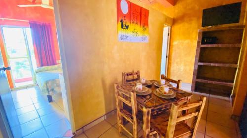 a dining room with a table and chairs in a room at Bungalows El Rincon de La Riviera in Rincon de Guayabitos