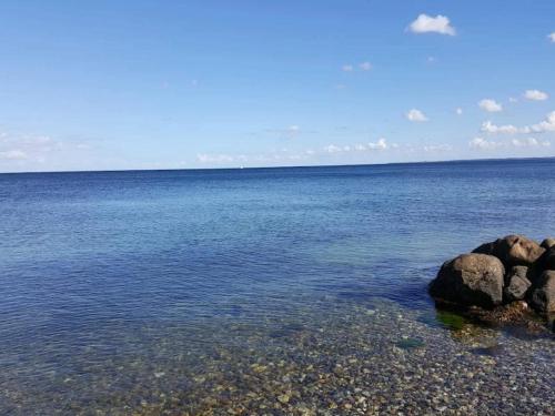 a large body of water with rocks in the water at 4 person holiday home in Frørup-By Traum in Frørup