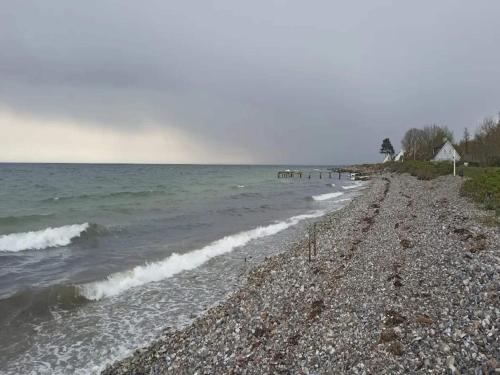 a rocky beach with waves in the water at 4 person holiday home in Frørup-By Traum in Frørup