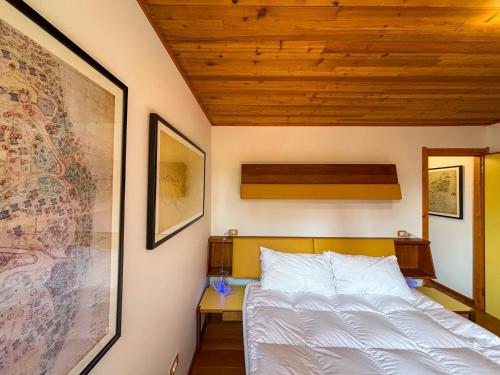 a bedroom with a bed and a picture on the wall at Chalet Auralpina near Cortina Olympics Games 2026 in Borca di Cadore