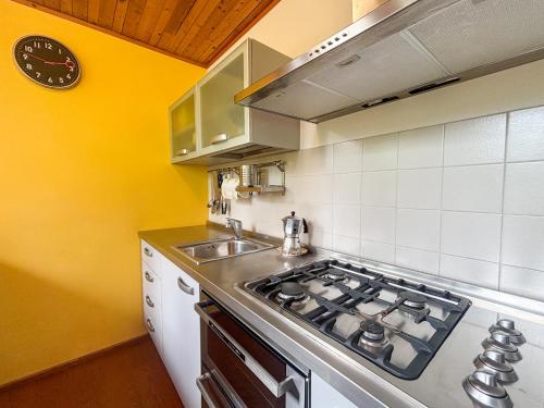 a kitchen with a stove and a sink at Chalet Auralpina near Cortina Olympics Games 2026 in Borca di Cadore