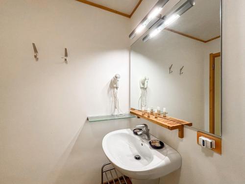 a bathroom with a sink and a mirror at Chalet Auralpina near Cortina Olympics Games 2026 in Borca di Cadore