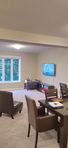 a living room with a table and chairs and a tv at 3BR Townhome Wright Dr Midland Near Little Lake in Midland