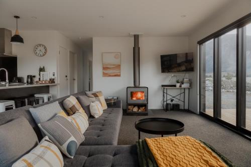 a living room with a couch and a fireplace at Manuka Vista in Twizel