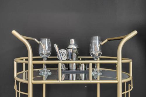 a wine rack with glasses and bottles on it at Luxe King 4 BR Townhouse Mins to Dwtn Durham in Durham