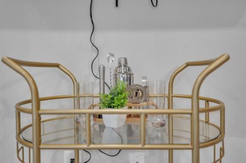 a glass and metal chandelier with a plant on it at Luxe King 4 BR Townhouse Mins to Dwtn Durham in Durham