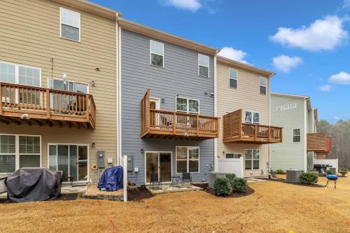 a house with two decks and a yard at Luxe King 4 BR Townhouse Mins to Dwtn Durham in Durham